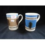 A BLUE AND BLACK BANDED MOCHA WARE TANKARD, decorated with trees and another similar, 13cm high