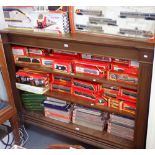 AN OAK BOOKCASE on bun feet with adjustable shelves, 125cm high x 163cm wide