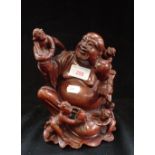 AN ORIENTAL CARVED WOODEN STUDY OF BUDDAH with attendants, 20cm high