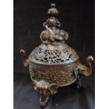 A CHINESE BRONZE TRIPOD CENSOR, the lid surmounted with a resting elephant, 30cm high