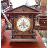 A LATE VICTORIAN WALNUT CASED MANTEL CLOCK