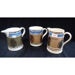 A 'QUART' MOCHA WARE MEASURING JUG, another similar and a large tankard, each with blue and black ba