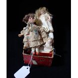 A MINIATURE EDWARDIAN BISQUE HEADED DOLL 14cm high and two similar