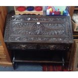 A VICTORIAN CARVED OAK BUREAU, 93cm wide