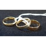 THREE YELLOW GOLD WEDDING BANDS, one 22ct, one 18ct and the other stamped "585", approx 7.3 grams to
