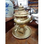 A BRASS SAMOVAR and a circular brass tray (2)