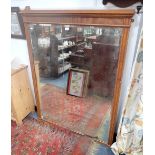 AN EDWARDIAN OAK FRAMED OVER MANTEL MIRROR with original bevelled plate, 142cm high x 113cm wide