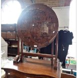 A CARVED FAR EASTERN HARDWOOD TABLE, the circular top with a plate glass top