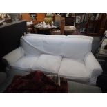 A CONTEMPORARY HOWARD STYLE THREE SEATER SOFA