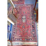 A RED GROUND PERSIAN STYLE RUG