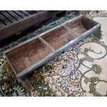 A GALVANISED METAL ANIMAL FEEDING TROUGH