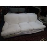 A CONTEMPORARY HOWARD STYLE THREE SEATER SOFA