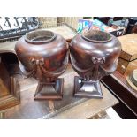 A PAIR OF CARVED HARDWOOD REGENCY STYLE URNS