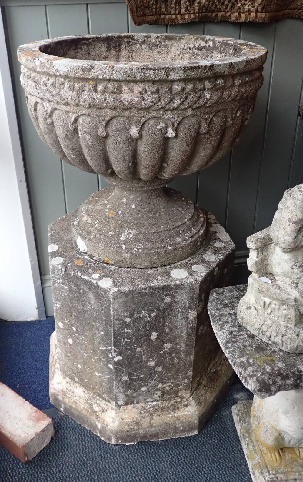 A PAIR OF RECONSTITUTED STONE GARDEN URNS