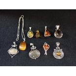 A COLLECTION OF SILVER AND WHITE METAL PENDANTS