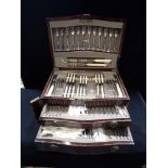 AN EDWARDIAN MAHOGANY CASED CANTEEN OF CUTLERY