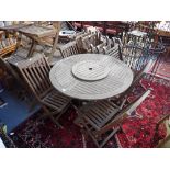 A TEAK CIRCULAR GARDEN TABLE