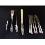 A SET OF SIX SILVER HANDLED BUTTER KNIVES