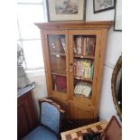 A GLAZED PINE CORNER CABINET