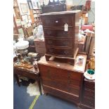 A REPRODUCTION MAHOGANY SERPENTINE CHEST OF DRAWERS
