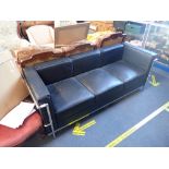 A CONTEMPORARY BLACK LEATHER AND CHROME SOFA