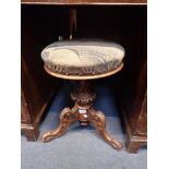 A VICTORIAN CARVED WALNUT PIANO STOOL