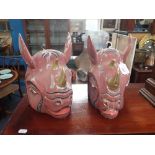 A PAIR OF CARVED AND PAINTED WOOD SOUTH EAST ASIAN RHINOCEROS HEADS