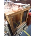 A GLAZED OAK DISPLAY CABINET