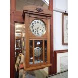 A 1930s OAK CASED WALL CLOCK