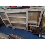 A CARVED AND STRIPPED OAK BREAKFRONT OPEN BOOKCASE