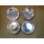 A SET OF FOUR SILVER PLATED CHRISTOFLE COASTERS engraved with the letter, "P"