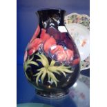 A MOORCROFT VASE, with a dark blue background