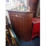 A GEORGE III OAK HANGING CORNER CUPBOARD