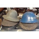 A STEEL POLICE HELMET, and four other steel helmets