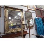 A REPRODUCTION GILT FRAMED WALL MIRROR