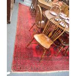 A LARGE RED GROUND RUG