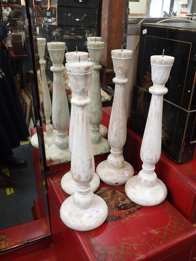 A SET OF FOUR WOODEN CANDLESTICKS