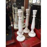 A SET OF FOUR WOODEN CANDLESTICKS