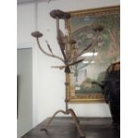 A WROUGHT IRON FIVE BRANCH CANDELABRA