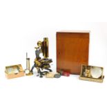 Victorian brass monocular microscope with accessories and case by W Watson and Sons of London,