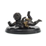 Patinated bronze model of a cherub raised on an oval marble base, 18.5cm wide : For Further