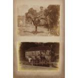 Antique black and white photographs arranged in two albums including classic trucks, buildings and