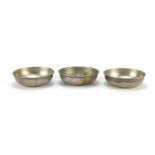 Set of three unmarked silver coin dishes, 8.5cm in diameter, 147.8g : For Further Condition