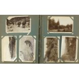 Early 20th century black and white photographic postcards arranged in an album including railway