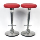 Pair of contemporary polished aluminium bar stools with red leather seats and ball and claw