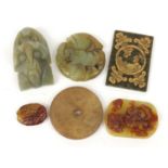 Chinese carved jade and hardstone discs and a belt hook, the largest 6.5cm in length : For Further