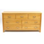 Contemporary light oak seven drawer chest, 76cm H x 146cm W x 42cm D : For Further Condition Reports