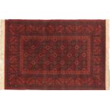 Red ground rug with all over geometric design, 205cm x 140cm : For Further Condition Reports