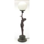 Bronzed table lamp in the form of a nude Art Deco dancer with globular glass shade, 69cm high :