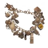 Silver charm bracelet with a large selection of mostly silver charms including animals, teapots